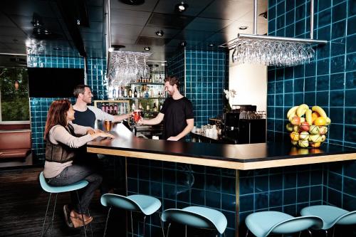 a group of people standing at a bar at Danhostel Copenhagen City & Apartments in Copenhagen