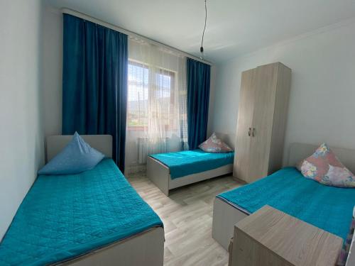 a bedroom with two beds and a window at Guest House Arcabay-Karligash in Saty