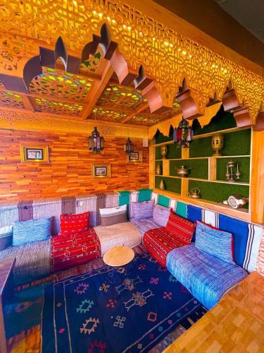 a room with a couch and a table in it at Riad Verus in Fès