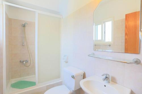 a bathroom with a toilet and a sink and a shower at Villa Aphrodite Finiki in Polis Chrysochous