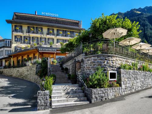 a building with stairs in front of a building at Hotel Schönegg in Wengen