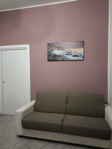 a living room with a couch and a picture on the wall at Il filo di Claudia in Savona
