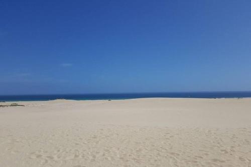 a sandy beach with the ocean in the background at Beach front apartment with stunning ocean views! in Costa Calma