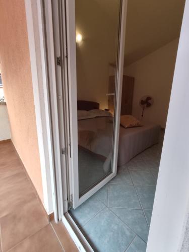 a mirror in a room with a bedroom at Summer vibe in Vir