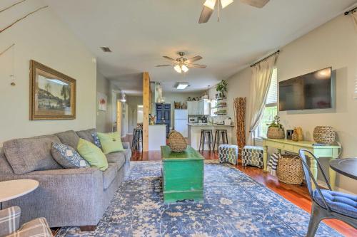 a living room with a couch and a kitchen at Bayou La Batre Stilted House on Snake Bayou! in Bayou La Batre
