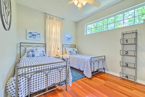 a bedroom with two beds and a window at Bayou La Batre Stilted House on Snake Bayou! in Bayou La Batre