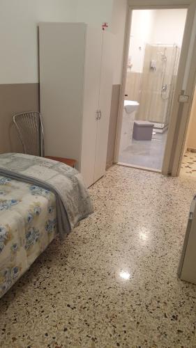 a bedroom with a bed and a bathroom with a shower at I MORI IN CAMPIDOGLIO AFFITTA CAMERE in SantʼAgata di Militello