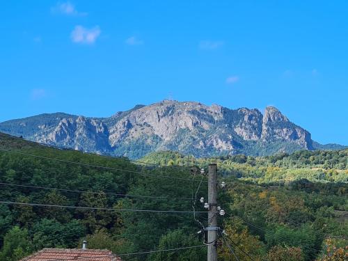 a mountain in the distance with power lines at Casa Hera in Călimăneşti