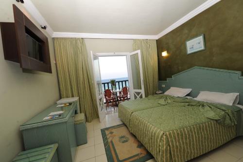 a hotel room with a bed and a balcony at Hotel Royal Beach in Sousse