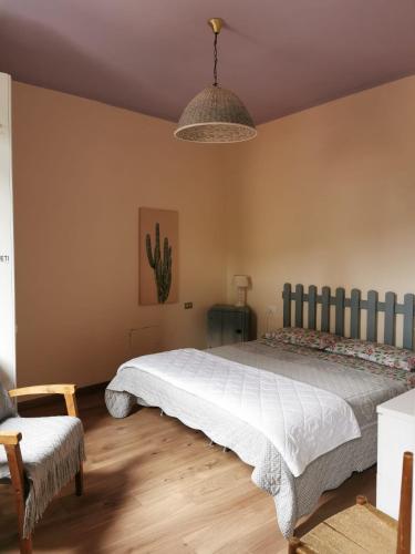 a bedroom with a large bed and a chair at Itaca in Varazze
