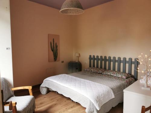 a bedroom with a bed and a chair at Itaca in Varazze