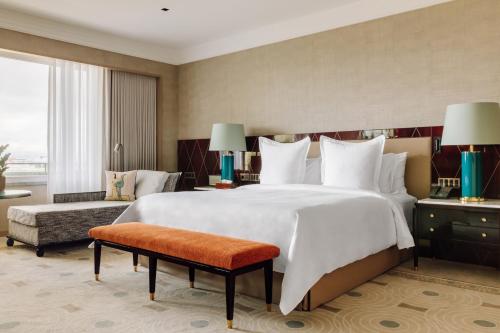 a bedroom with a large bed and a large window at Four Seasons Hotel Ritz Lisbon in Lisbon
