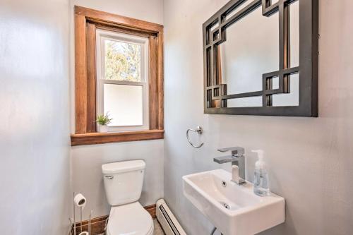 a bathroom with a toilet and a sink and a mirror at Bright and Sunny Abode, 2 Mi to Hersheypark! in Hershey