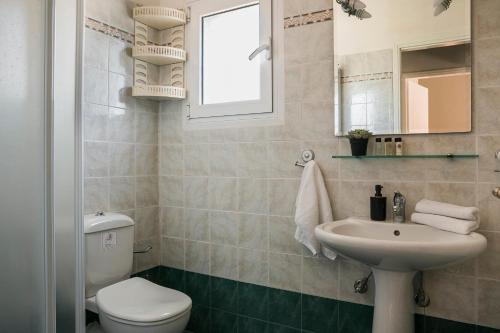 a bathroom with a toilet and a sink at Emily Villas in Sami