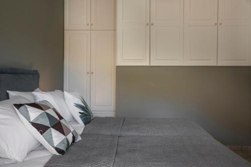 a bedroom with a bed with white cabinets at Emily Villas in Sami