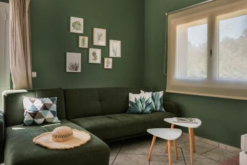 a living room with a green couch and a window at Emily Villas in Sami