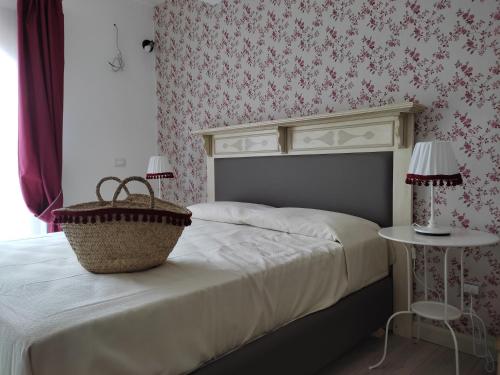 a bedroom with a bed with a basket on it at Etna Casa del Sole in Nicolosi