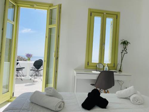 a bedroom with a bed and a view of the ocean at VILLA AGNES MYKONOS in Mýkonos City