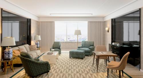 a living room with a couch and chairs and a piano at Four Seasons Hotel Ritz Lisbon in Lisbon