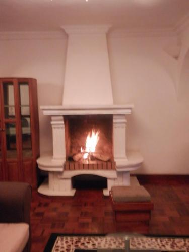 a fireplace in a living room with a fire in it at Iarimbato Hotel in Antananarivo