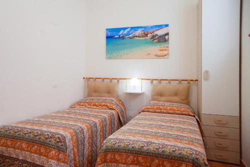 Ένα ή περισσότερα κρεβάτια σε δωμάτιο στο A Casa di Nicola - Goelba