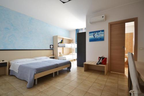 a bedroom with a bed with a blue wall at Hotel La Siesta in Torino di Sangro