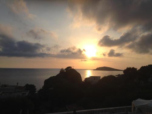 a sunset over the ocean with the sun setting at Alkyonis Apartments in Panormos Kalymnos