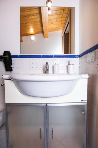 a bathroom with a white sink and a mirror at Kaary Venere in Marina di Ragusa