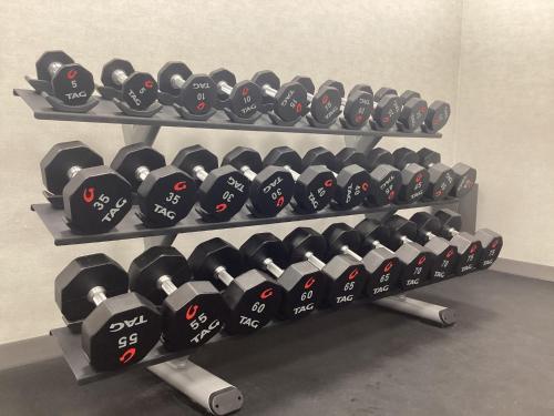 a row of dumbbells on a shelf in a gym at Hampton Inn by Hilton Port Hope Cobourg in Port Hope
