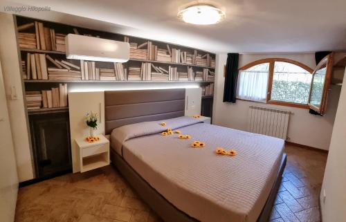 a bedroom with a large bed with pumpkins on it at Villaggio Heliopolis in Manerba del Garda