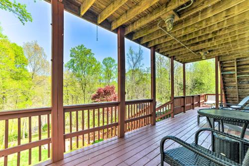 a screened in porch with two benches and a table at Cadiz Abode with Decks, Fire Pit, and Lake Access in Cadiz