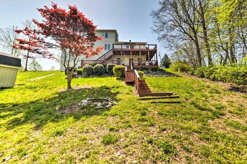a house on a hill with a tree in the yard at Cadiz Abode with Decks, Fire Pit, and Lake Access in Cadiz