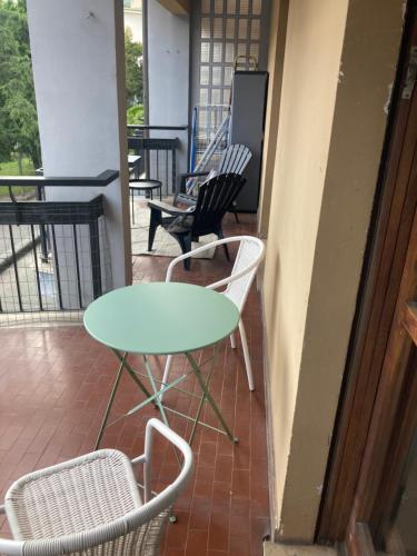 a table and two chairs on a porch at A casa di Niki in Aosta