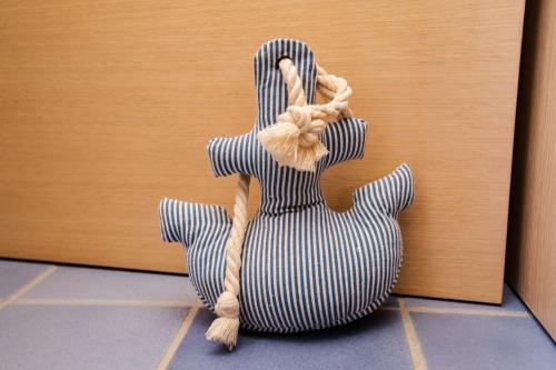 a stuffed animal is leaning against a door at Kaary Venere in Marina di Ragusa