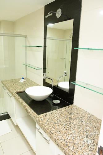 a bathroom with a sink and a mirror at VOA Ambassador Flat in João Pessoa