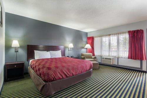 a hotel room with a bed and a window at ONE LIFE STUDIOS in Evansville