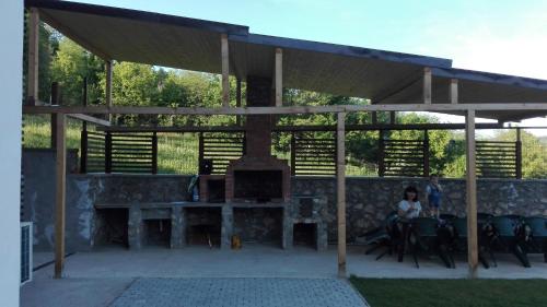 a pavilion with a woman sitting under it at Casa Sarti in Eşelniţa