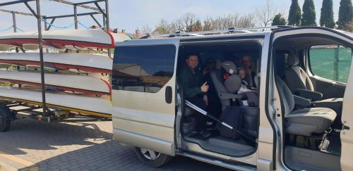 a group of people sitting in the back of a van at U Wileńskich in Wizna
