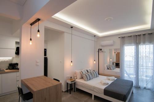 ein Wohnzimmer mit einem Bett und eine Küche in der Unterkunft Cozy Modern Studiο _ Near the Center of Athens in Athen