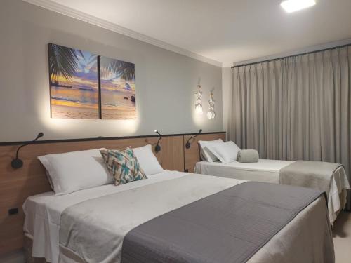 Cama o camas de una habitación en B14 Suítes