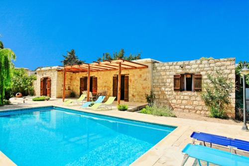 a swimming pool in front of a house at Simeon Estate in Droushia