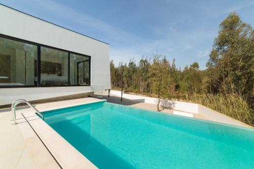 a swimming pool in a house with a view at Villa Floresta - By SCH in São Martinho do Porto