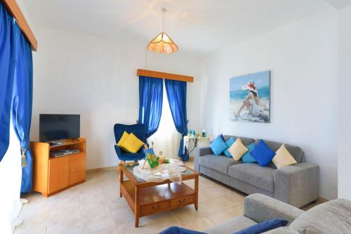 a living room with a couch and a table at Lemon Grove Villa Dio in Argaka