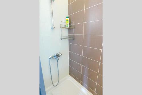 a bathroom with a shower with a tub at Villa Styliani in Droushia