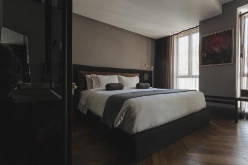 a bedroom with a large bed and a window at The Wild Oscar in Mexico City