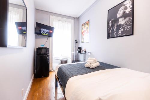 a bedroom with a bed with a teddy bear on it at The Central Park North in New York