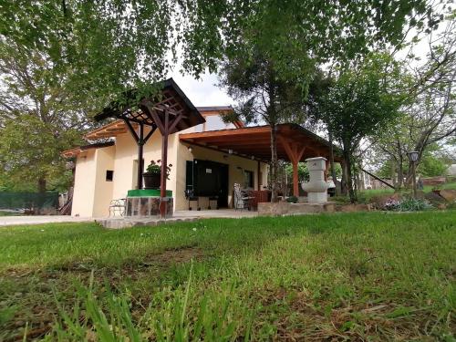 a house with a gazebo in a yard at Vila Mila Fruška Gora in Velika Remeta