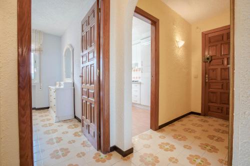 a hallway with a door and a room with a kitchen at Apartamento Rosmarin by MarCalma in Miami Platja