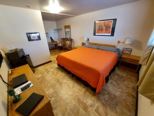 a hotel room with a bed and a table at Cactus Inn in McLean
