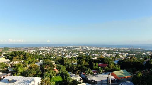 an aerial view of a city with the ocean at Bourbon Horizon in La Possession